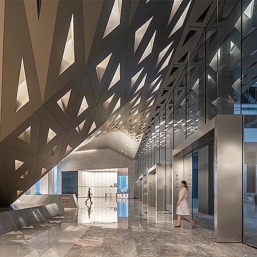 A couple of women walking down a hall way.